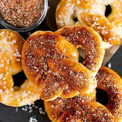 A plate of soft pretzels covered with zesty seasoning.