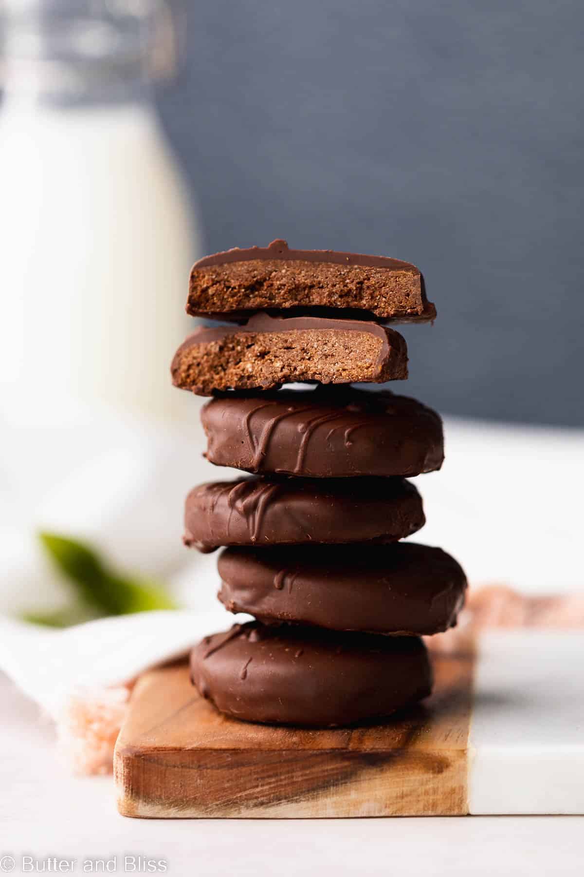 Stack of thin mint healthier cookies on a small wood tray on a table.