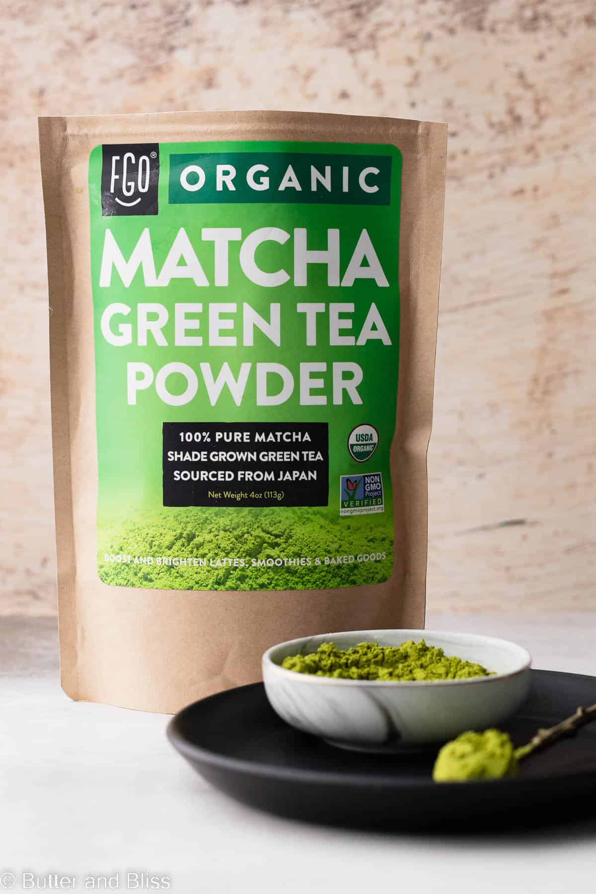Bag of green tea powder on a table.