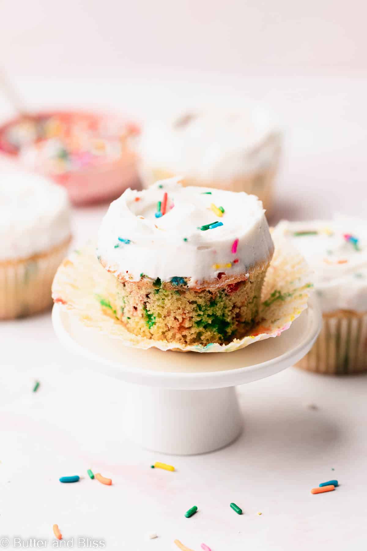 A single gluten free funfetti cupcake presented on a sweet mini cupcake stand.