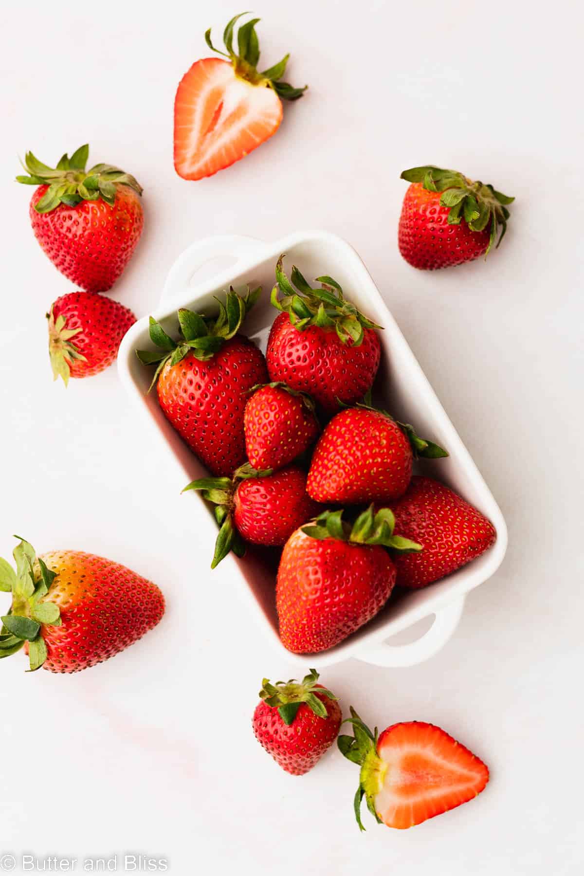 Fresh whole strawberries arranged in a pretty baking dish.