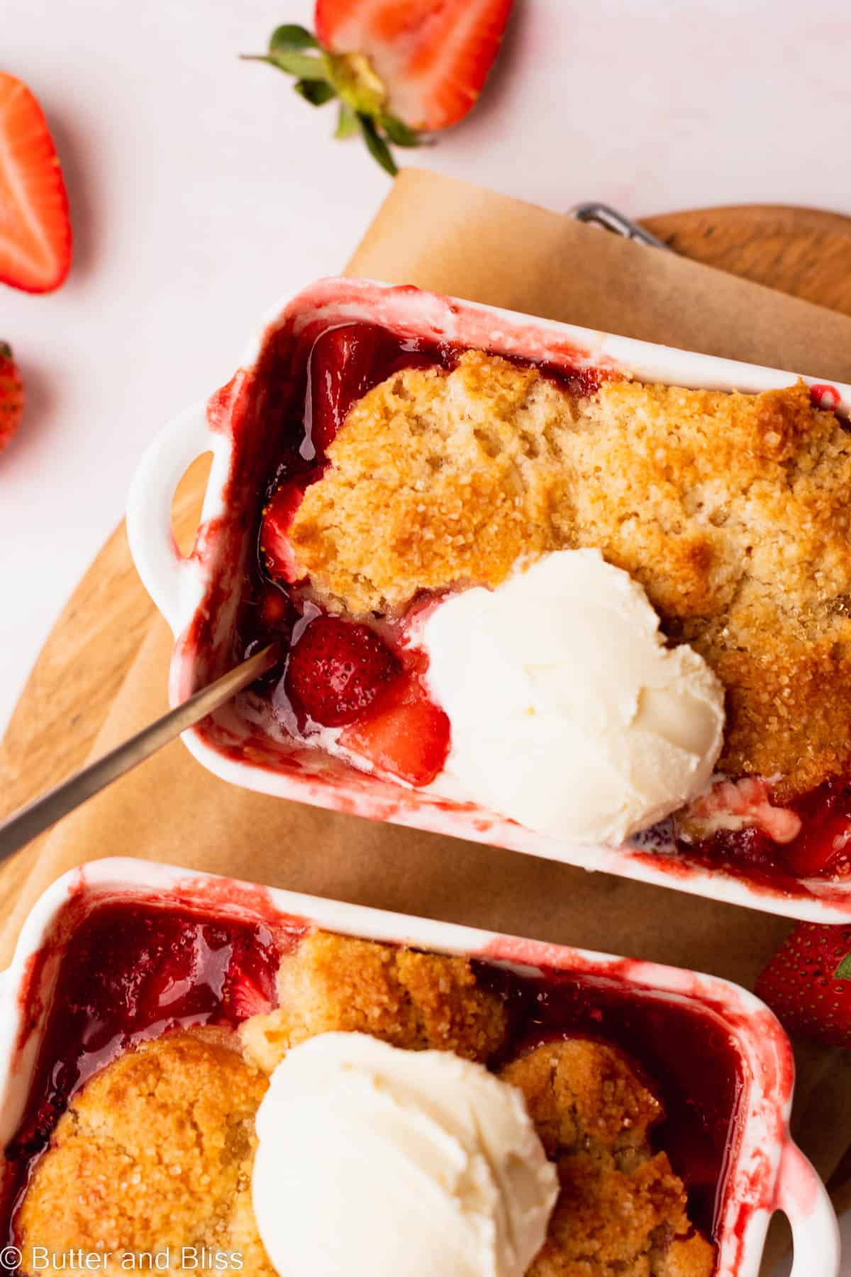 The gooey strawberry filling in a gluten free strawberry cobbler in a mini baking dish.
