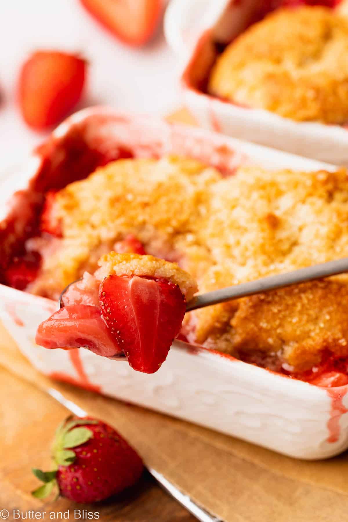 A delicious gooey spoonful of strawberry gluten free cobbler.