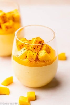 Super creamy mango mousse with mango chunk garnish in a pretty parfait glass.