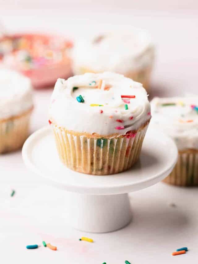 Perfectly frosted gluten free funfetti cupcake presented on a table.