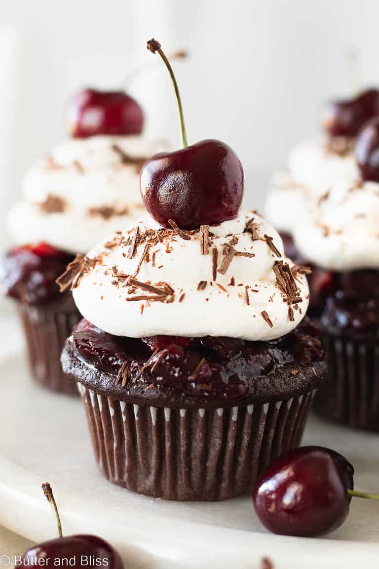 Small batch black forest dessert cupcakes on a white plate.