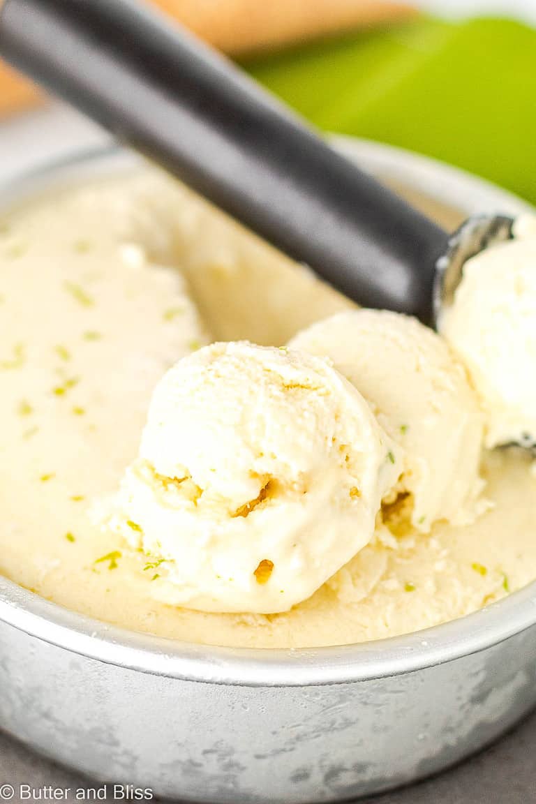 Creamy scoops of pina colada ice cream in an ice cream tin.