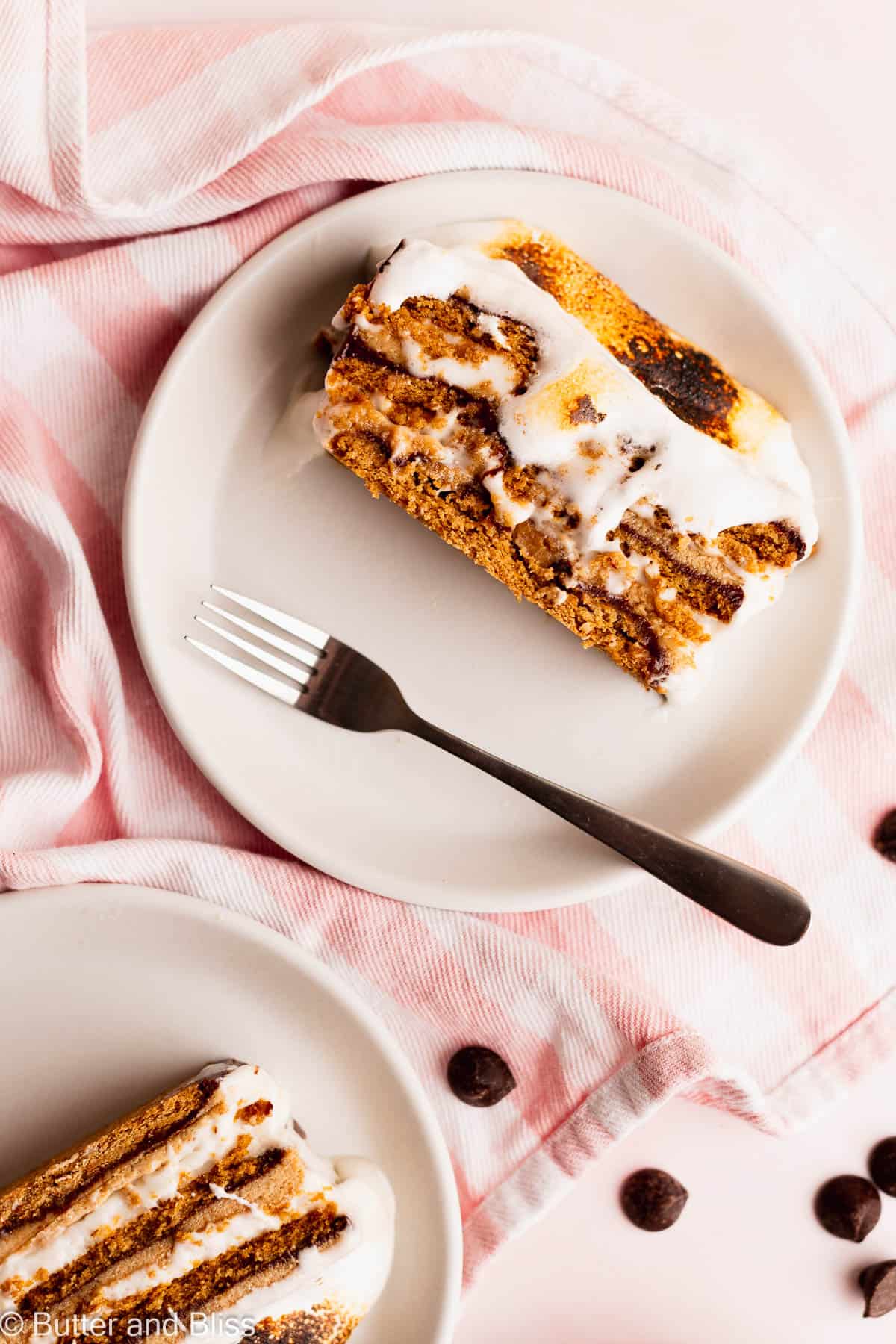Drippy layers of toasted marshmallow on a slice of peanut butter s'mores cake.