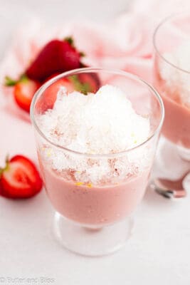 Slushy lemonade granita layered on strawberry pudding in a pretty parfait glass.