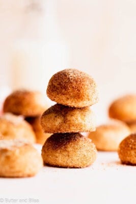 A pretty stack of cream cheese gluten free cookies coated in cinnamon sugar arranged on a table.
