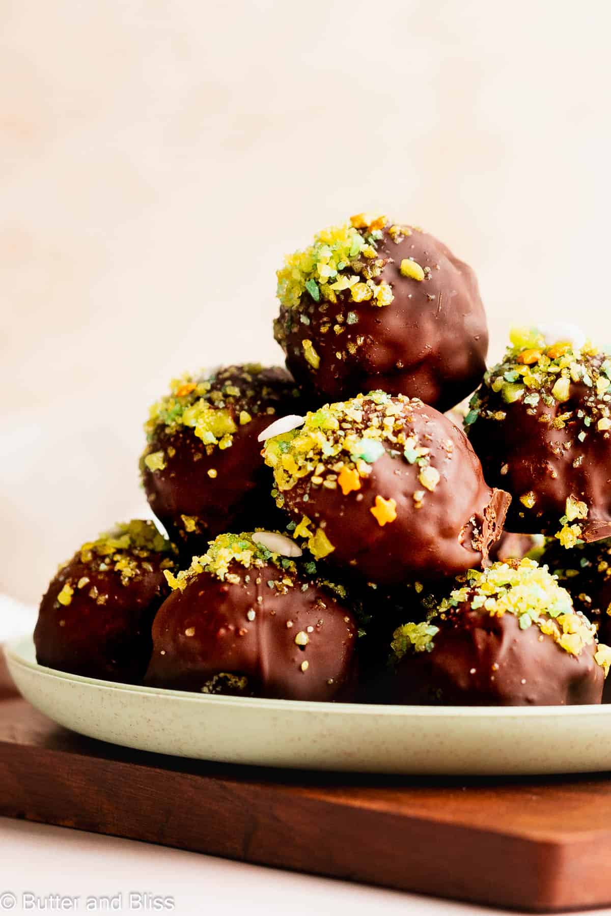 A pile of popping apple rice candy truffles on a small green plate.