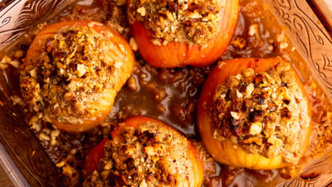 Fresh from the oven Hasselback apples topped with streusel in a pretty baking dish.
