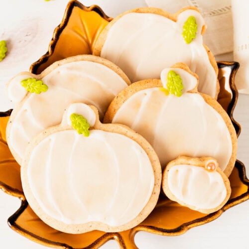 A pretty fall plate full of frosted pumpkin spice cookies.