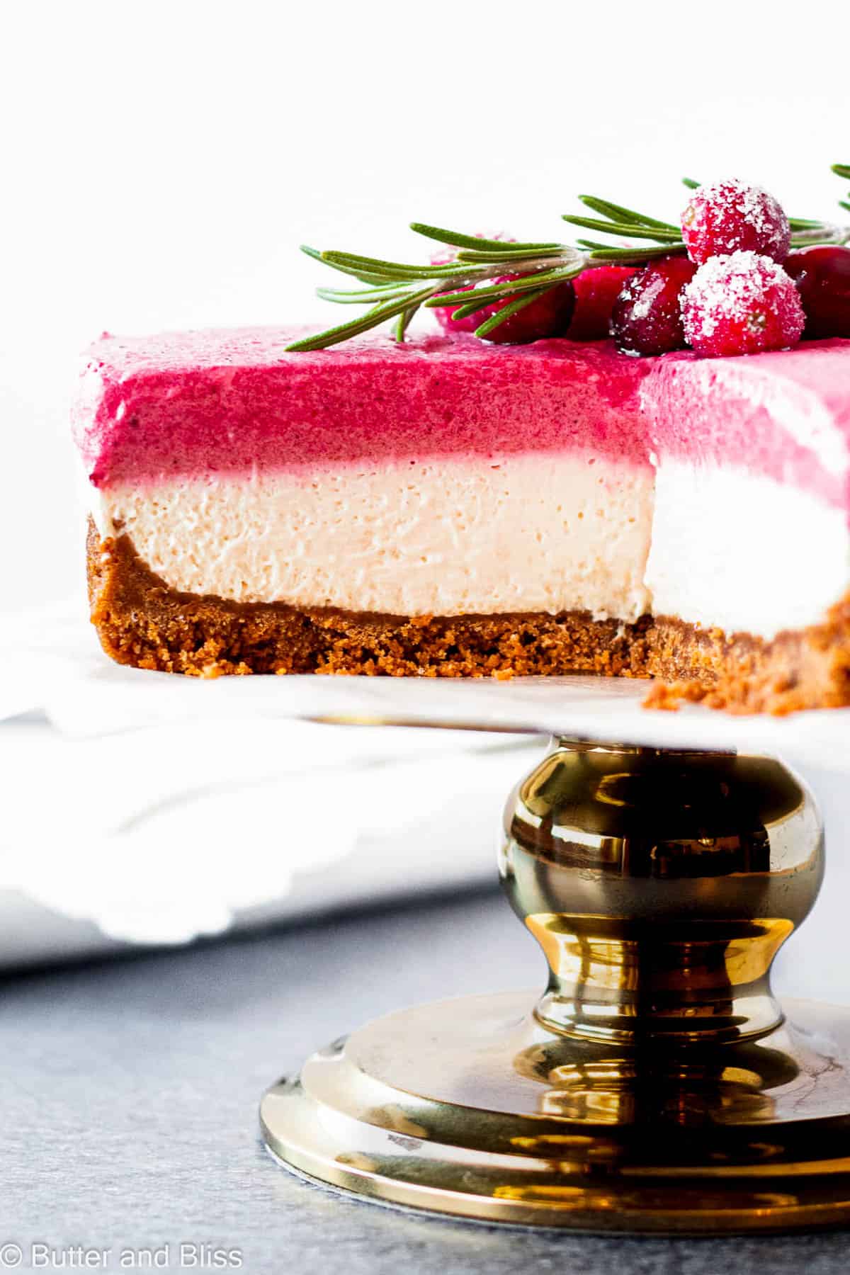 Velvety and creamy interior of a cranberry cheesecake on a cake stand.