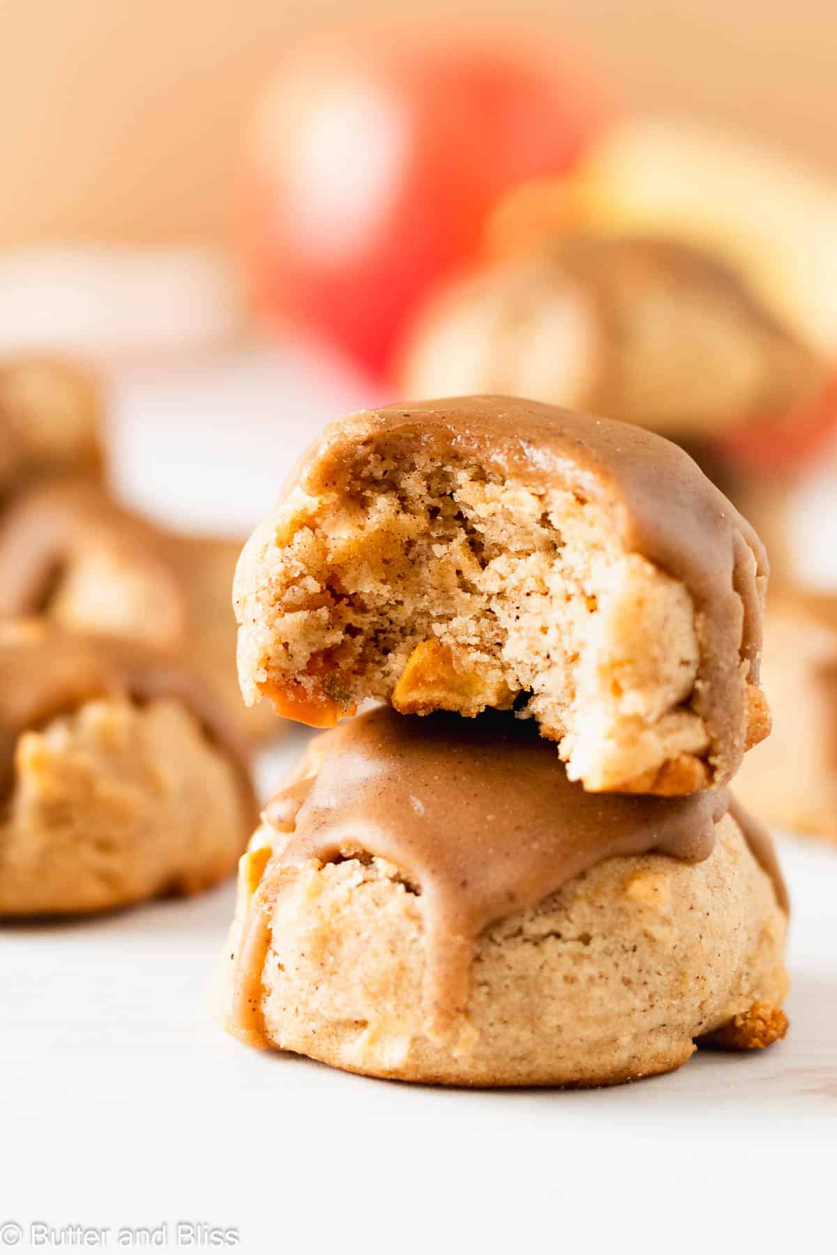 A beautiful bite shot of a soft caramel apple cookie stacked on another cookie.