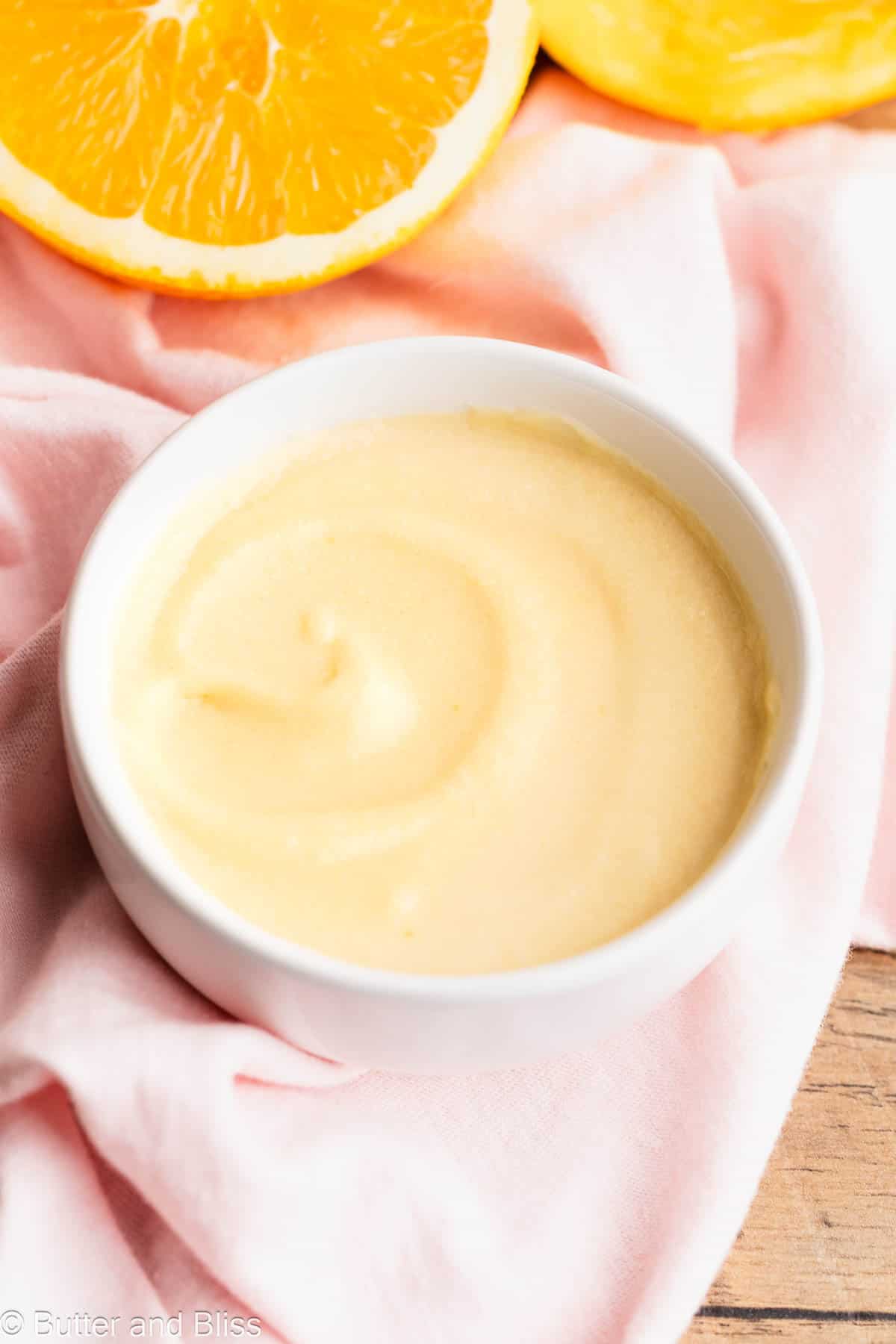Creamy caramel orange glaze in a pretty white bowl.