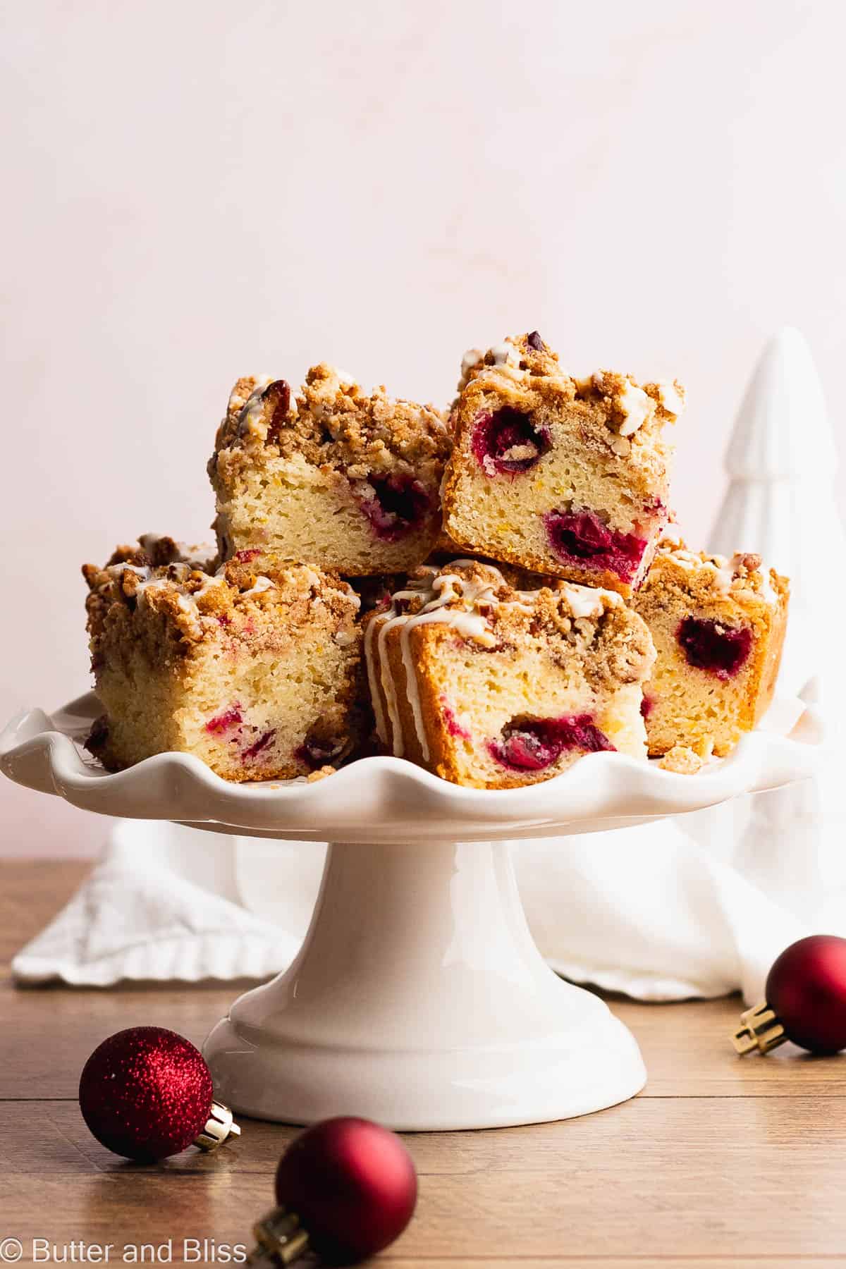 Pretty cake stand full of slices of cranberry gluten free coffee cake.