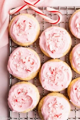 Peppermint pink frosted gluten free meltaways on a wire rack.