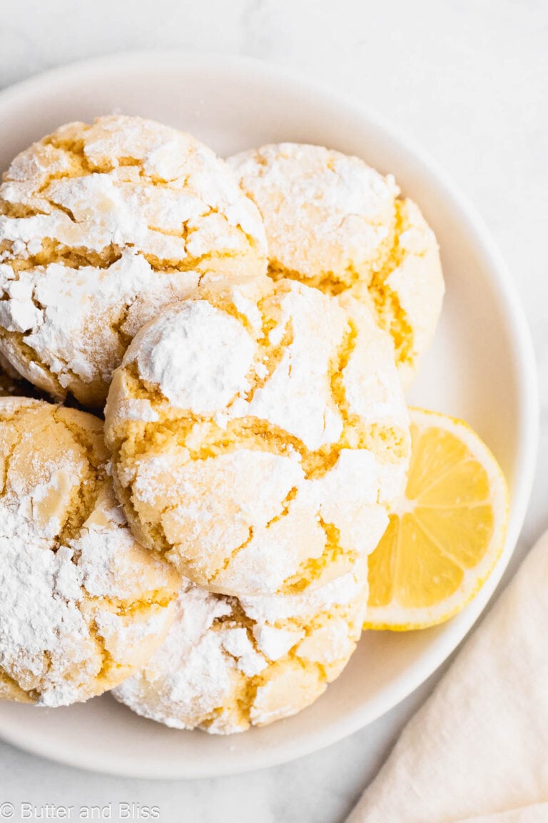 A plate of pretty holiday cookies dusted with powdered sugar.