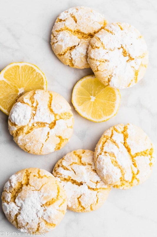 Gluten free lemon crinkle cookies arranged on a table.
