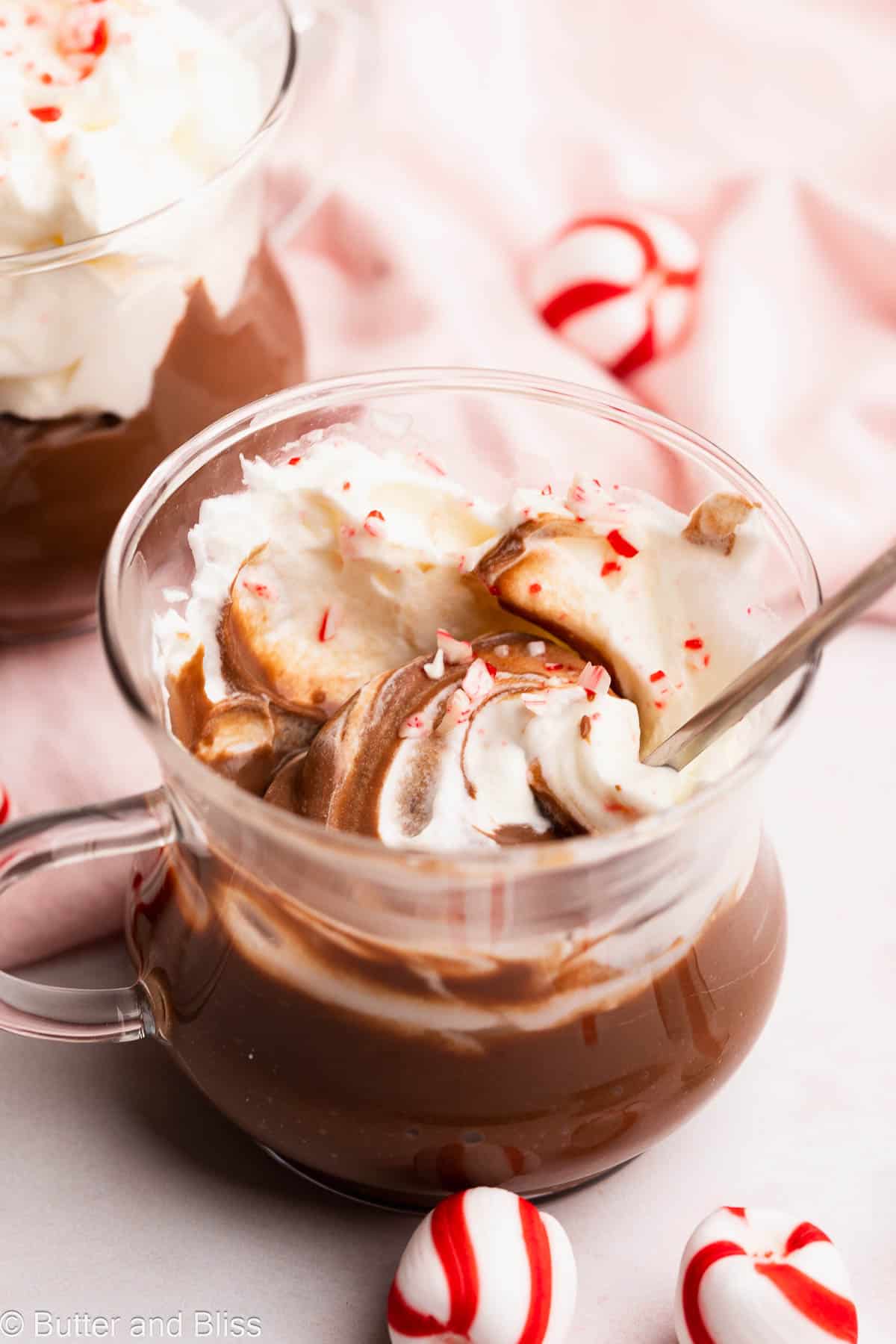 Extra creamy hot chocolate pudding swirled with whipped cream and candy canes.