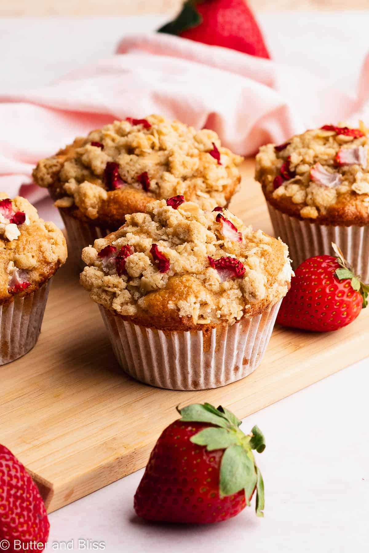 Small batch strawberry gluten free muffins on a wood serving tray.