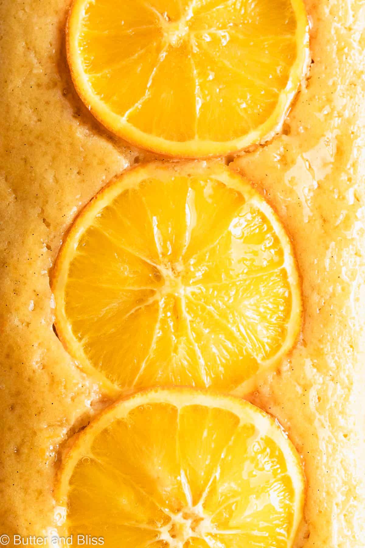 Close of of a delicious small batch orange snack cake with orange slices.