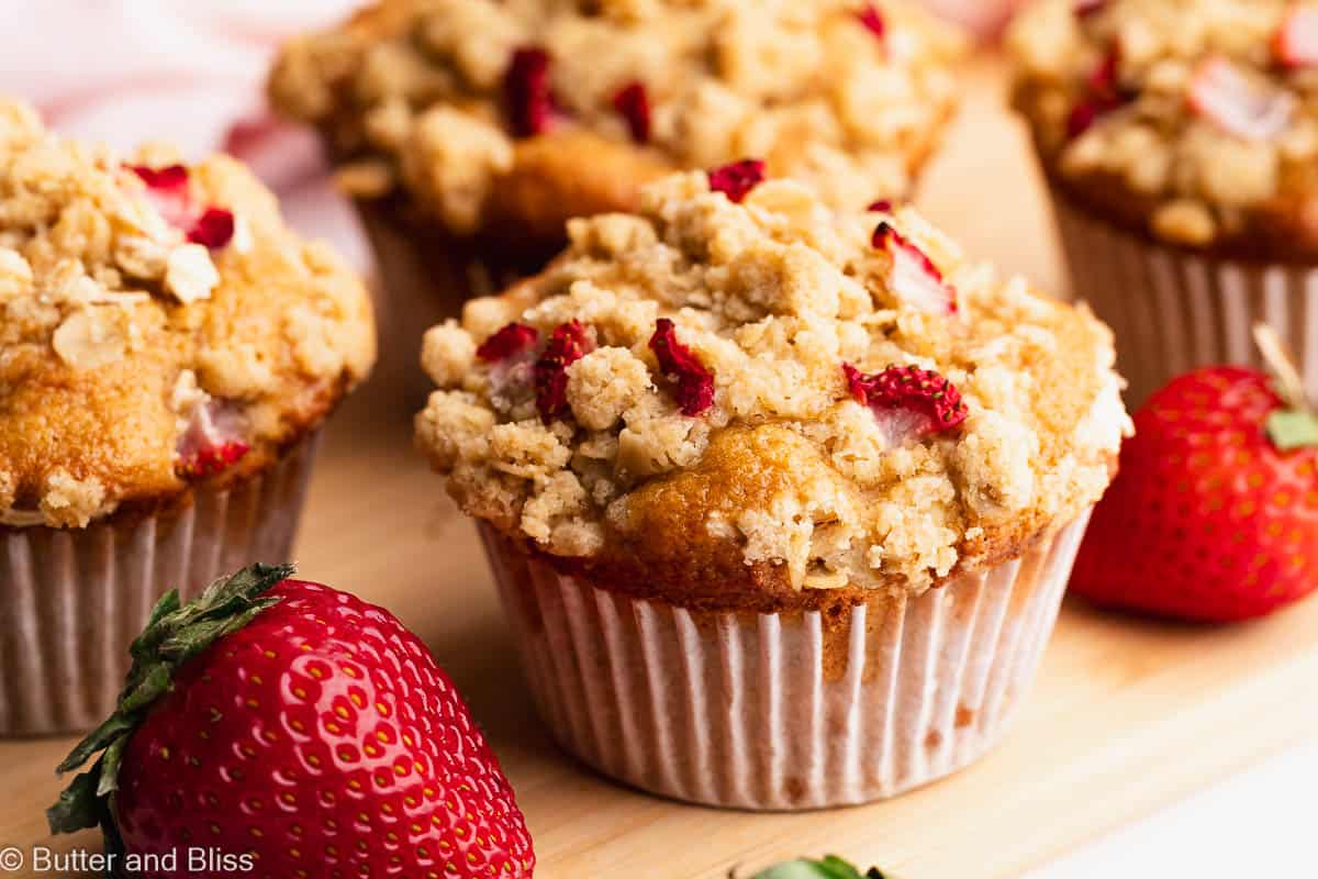 Close up of a freshly baked strawberry oatmeal streusel muffin on a tray.