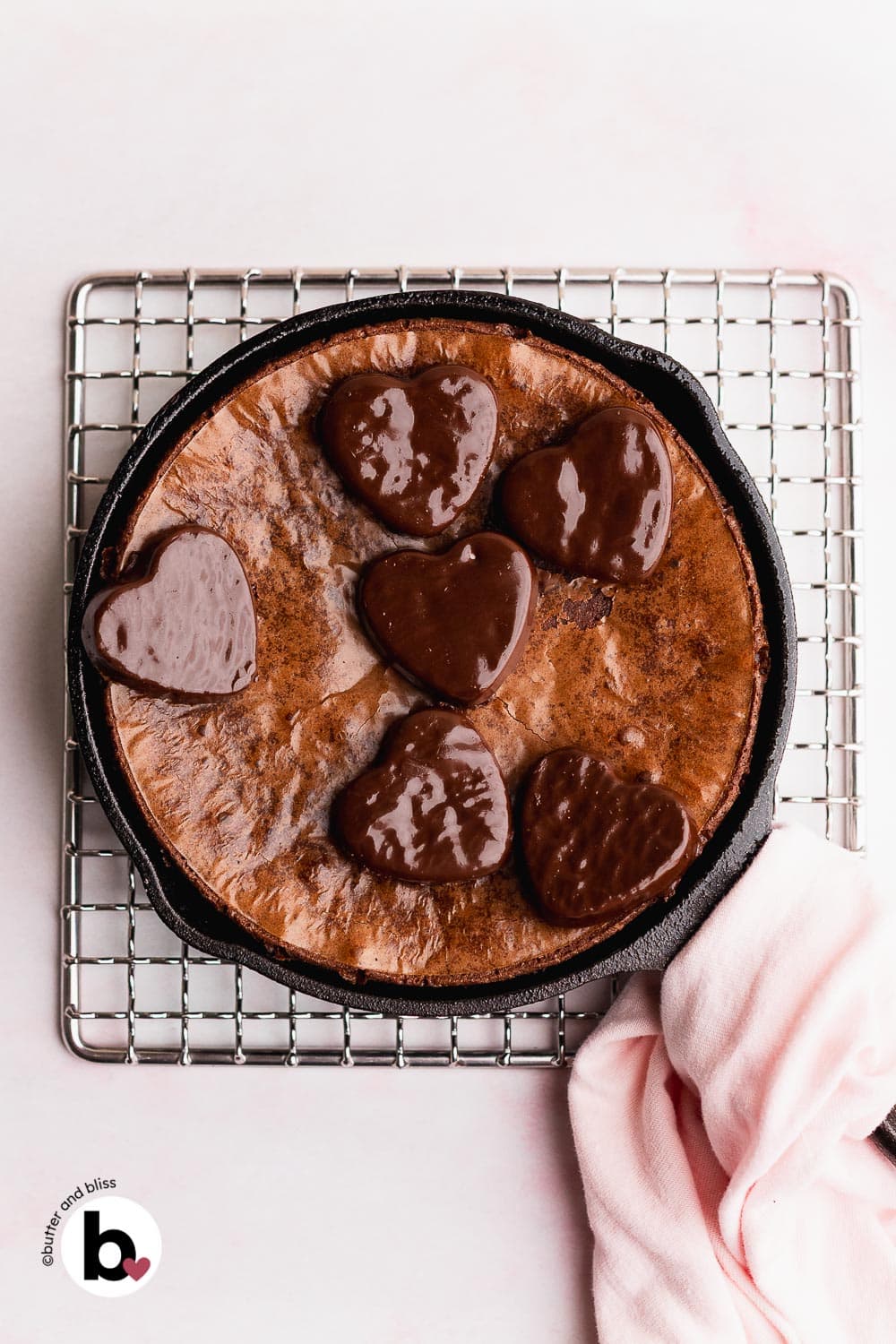 Small brownie for two in a mini skillet topped with heart candy.