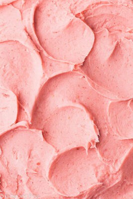 Close up of swirls of butter free strawberry frosting.