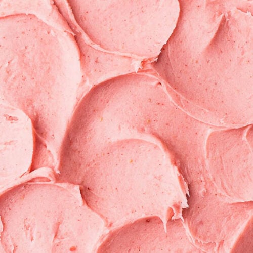 Close up of swirls of butter free strawberry frosting.