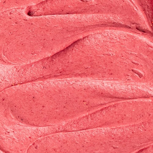 Vibrant and smooth close up of raspberry cookie frosting.
