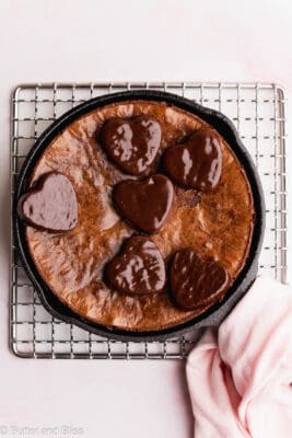 Beautiful small batch skillet brownie in a mini cast iron pan with super crackly top and heart candies.