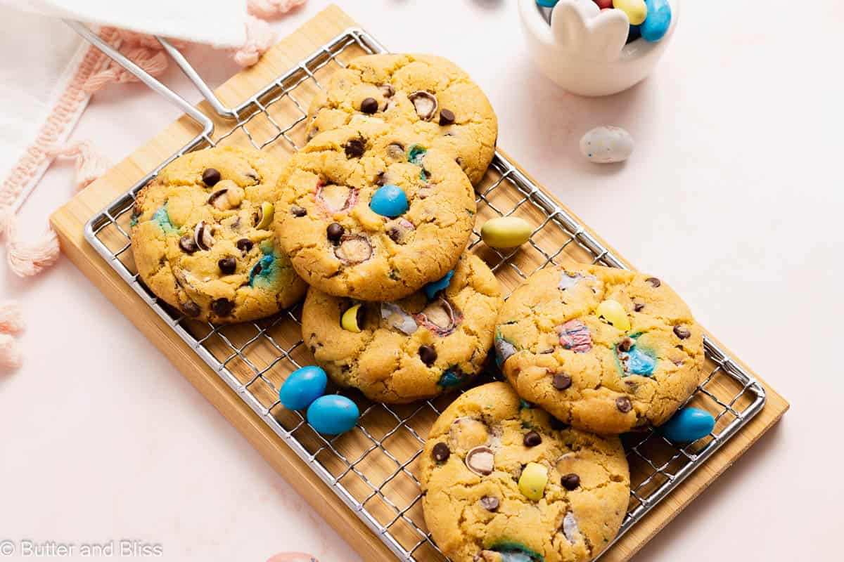 Freshly baked Easter egg chocolate chip cookies on a wire cooling rack.