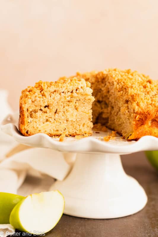 Moist inside of a slice of Irish apple cake on a cake stand.