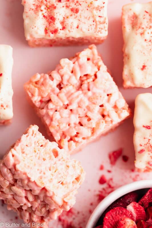 Close up of a strawberries and cream rice krispie treat square on a table.