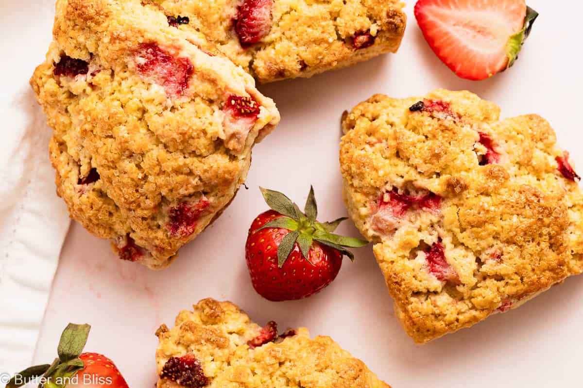 Freshly baked golden brown and delicious strawberry scones arranged on a table.