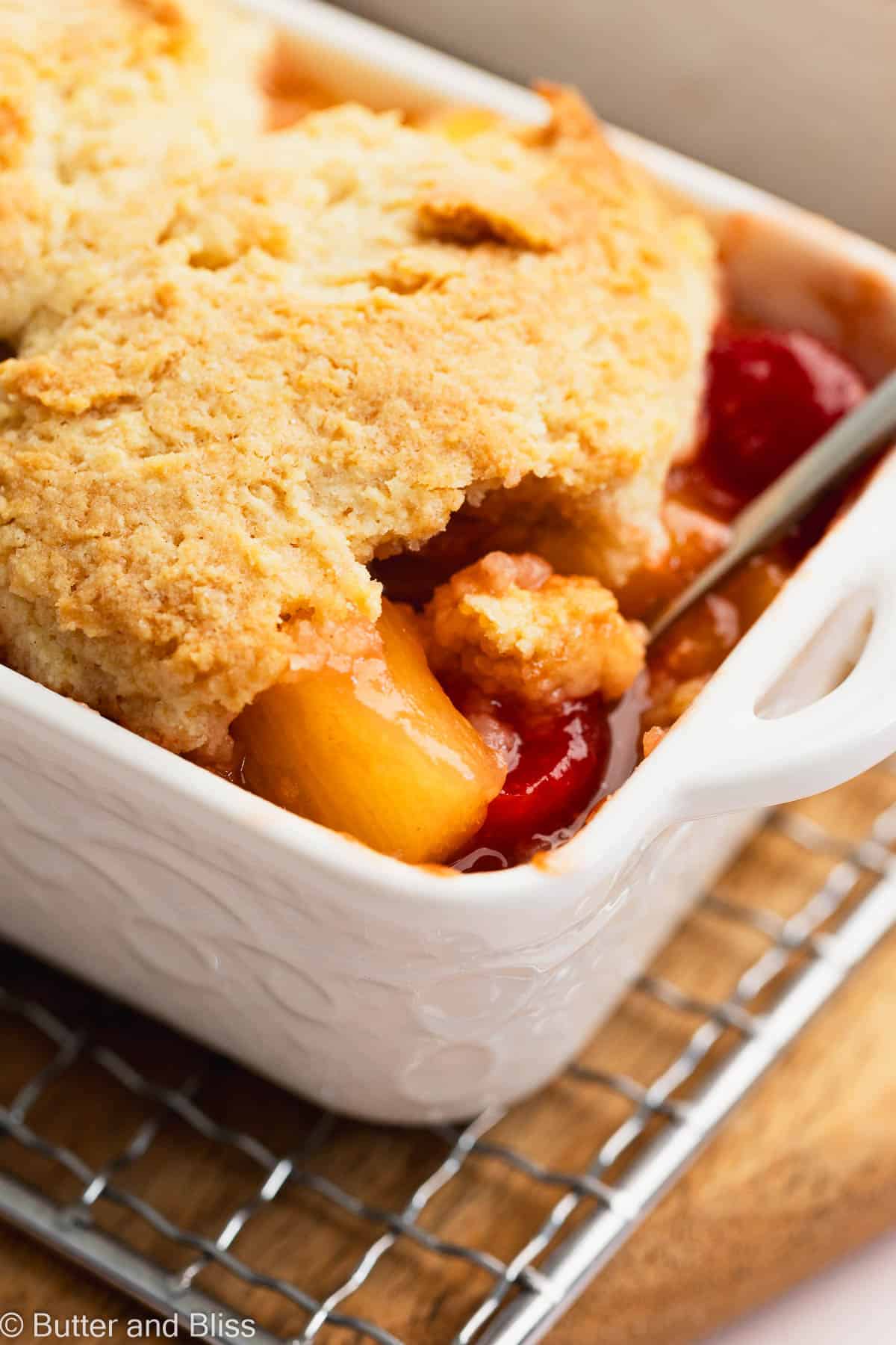 Gooey inside of a pineapple upside down cobbler with biscuit topping.