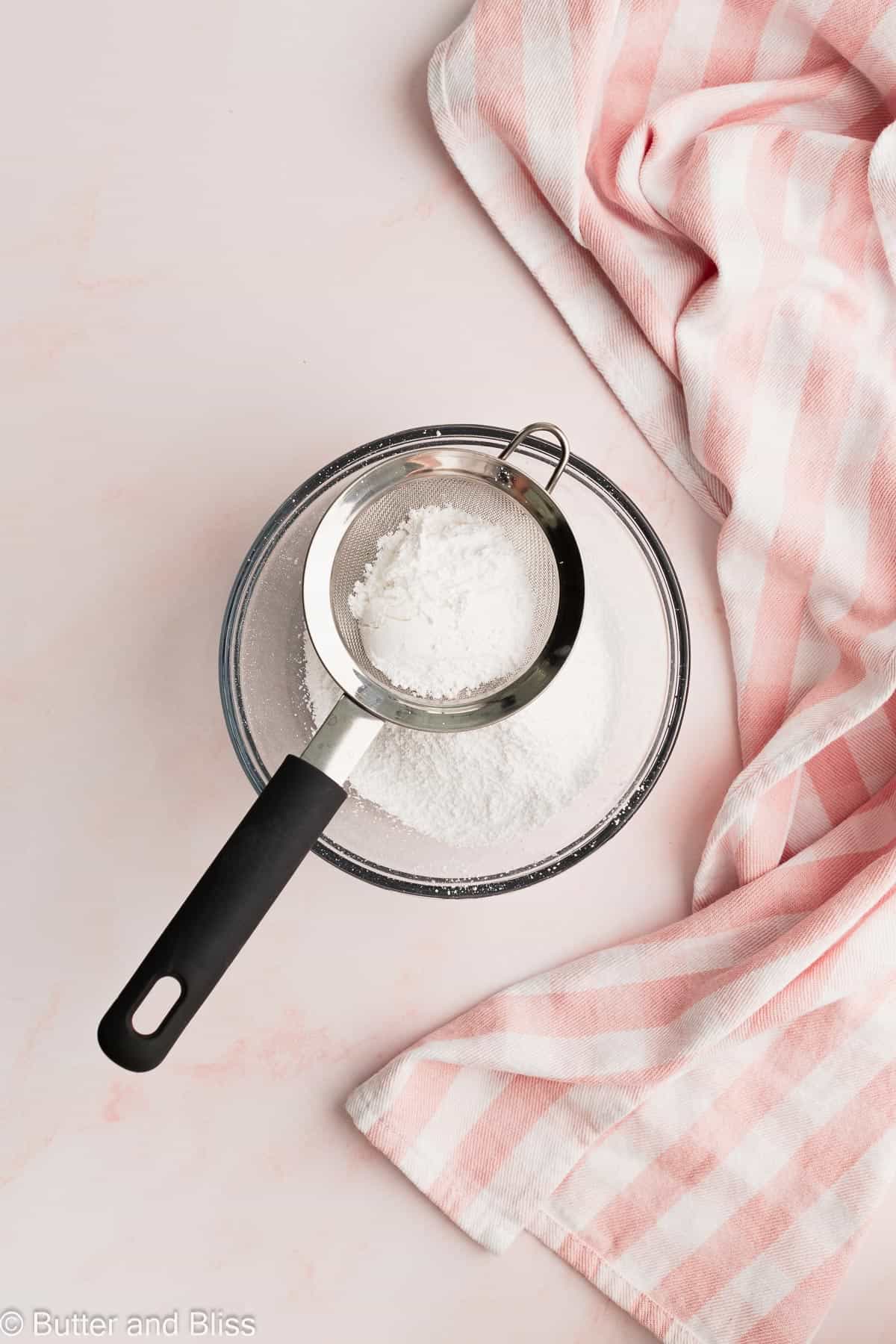 Powdered sugar sifted into a mixing bowl.