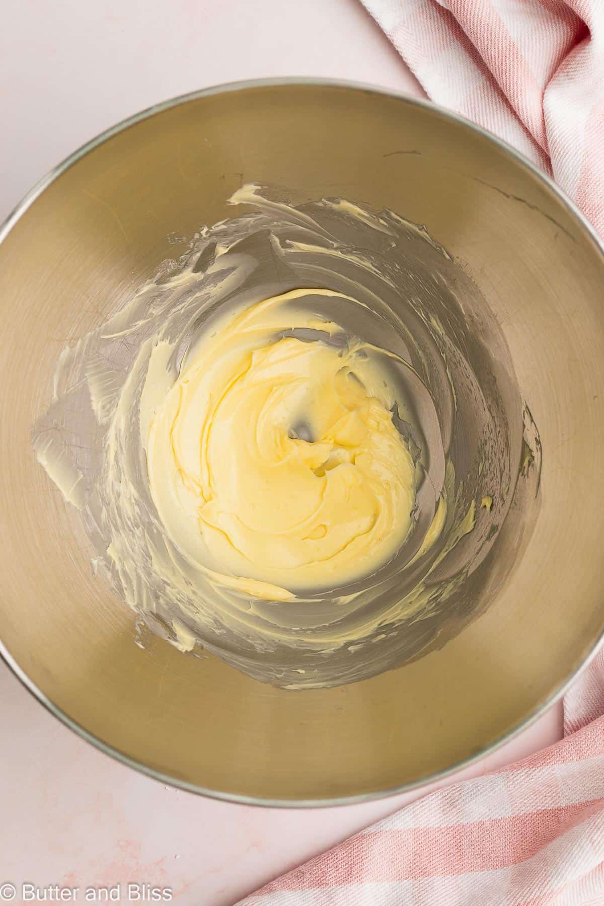 Super creamy butter in a mixing bowl.