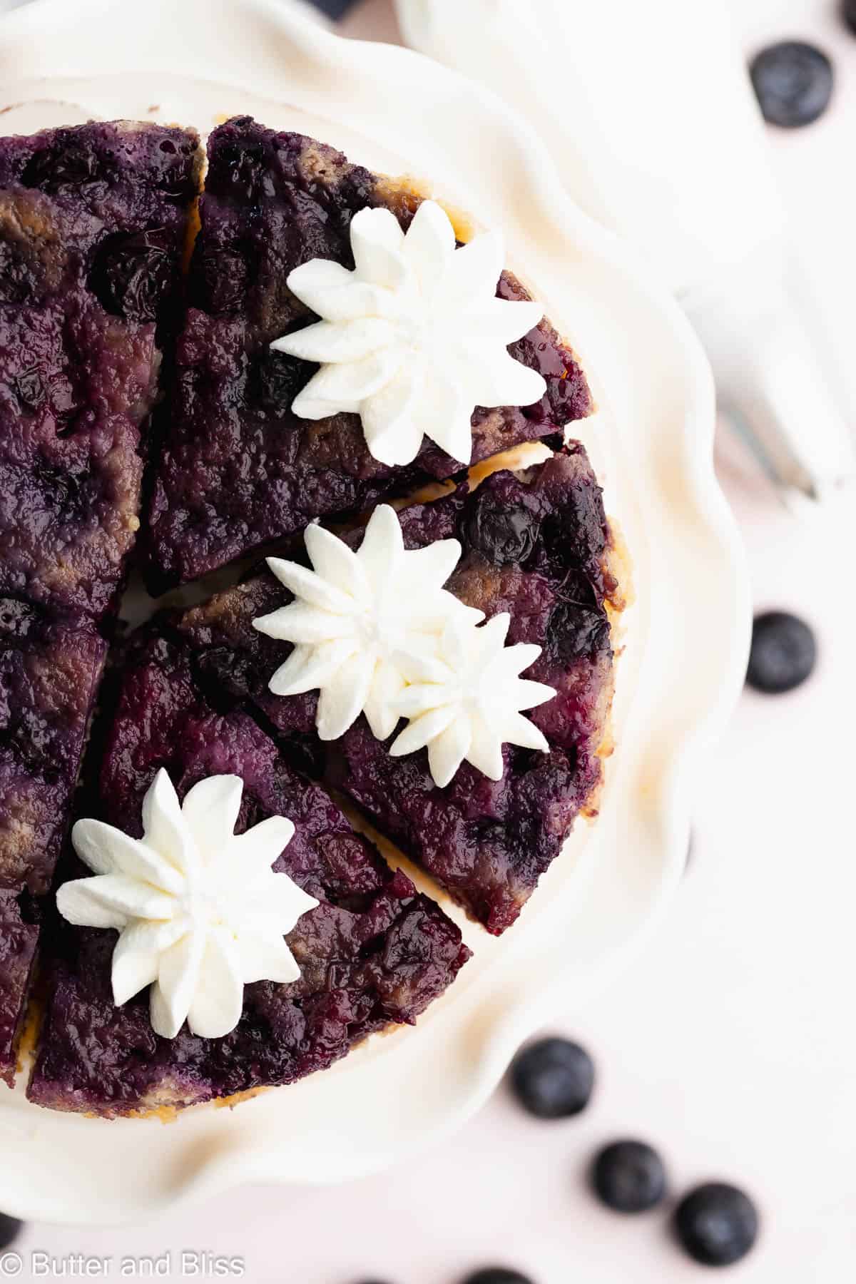 Pretty top view of blueberry lemon upside down cake topped with whipped cream stars.