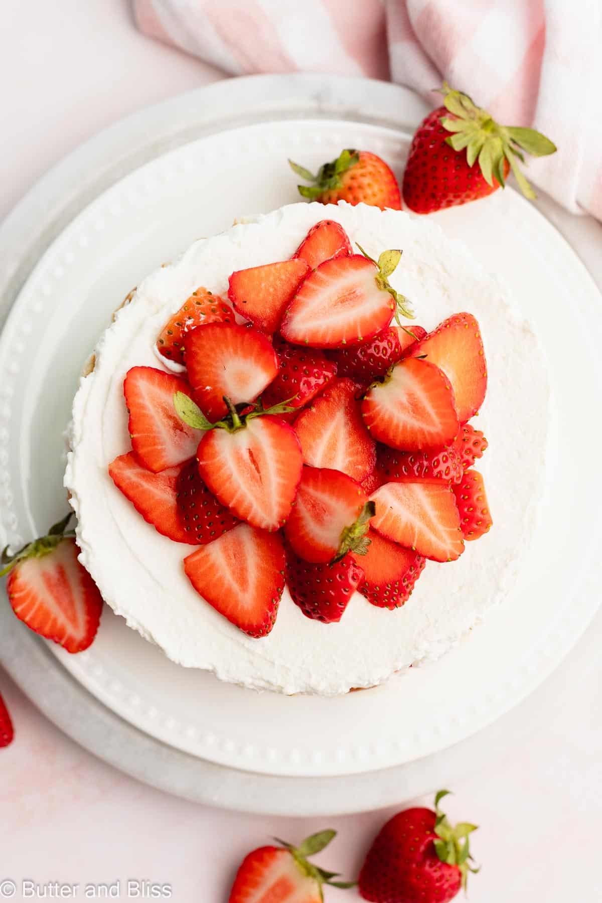 Small strawberry icebox cake from the top covered in fresh strawberry slices.