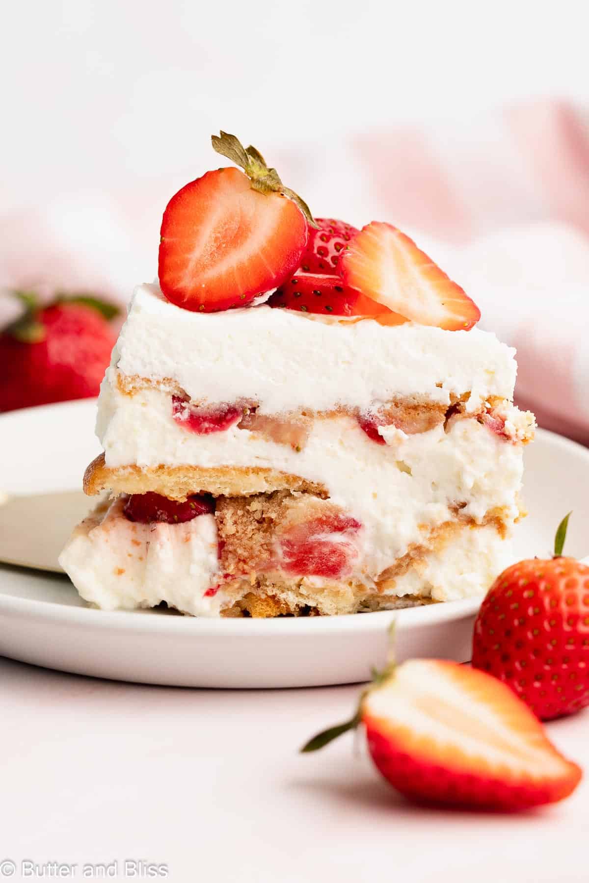 Perfect slice of strawberry icebox cake on a white plate.