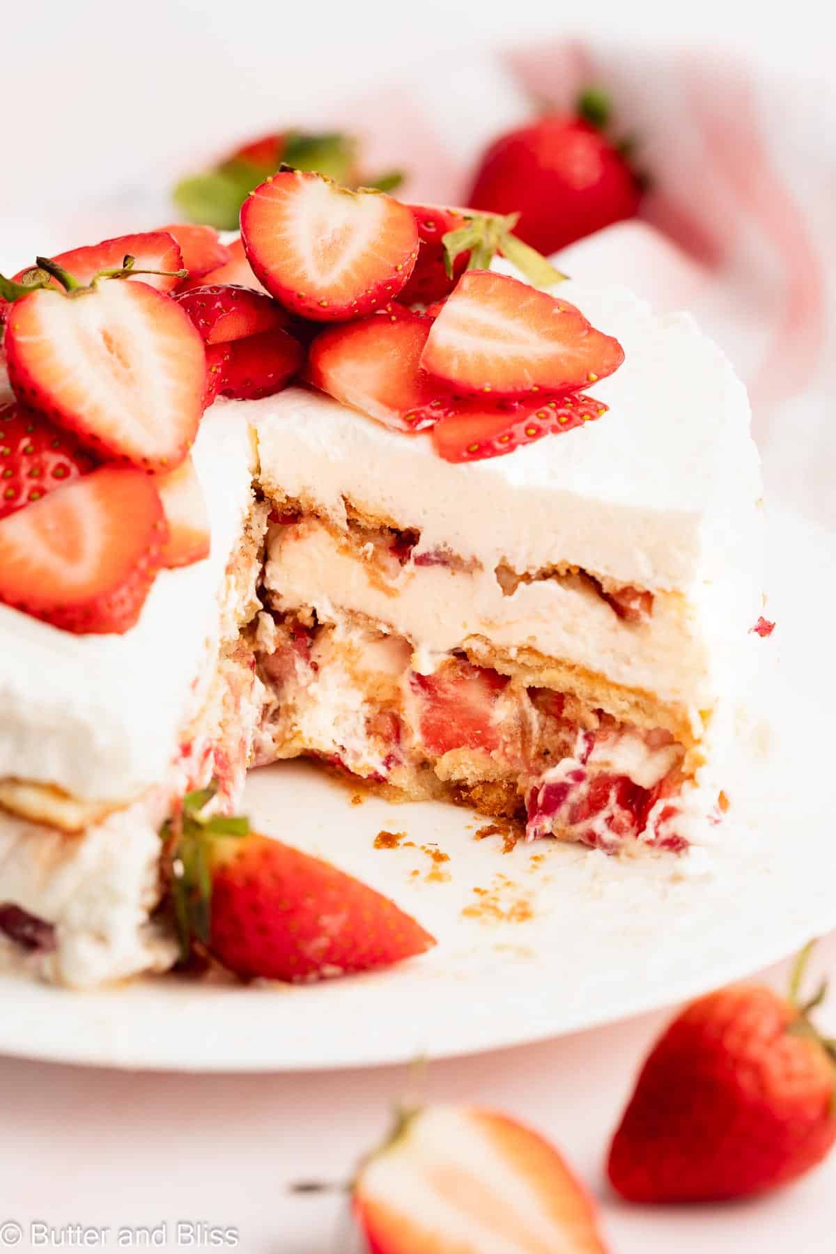 Layered inside of a strawberry icebox cake on a white platter.