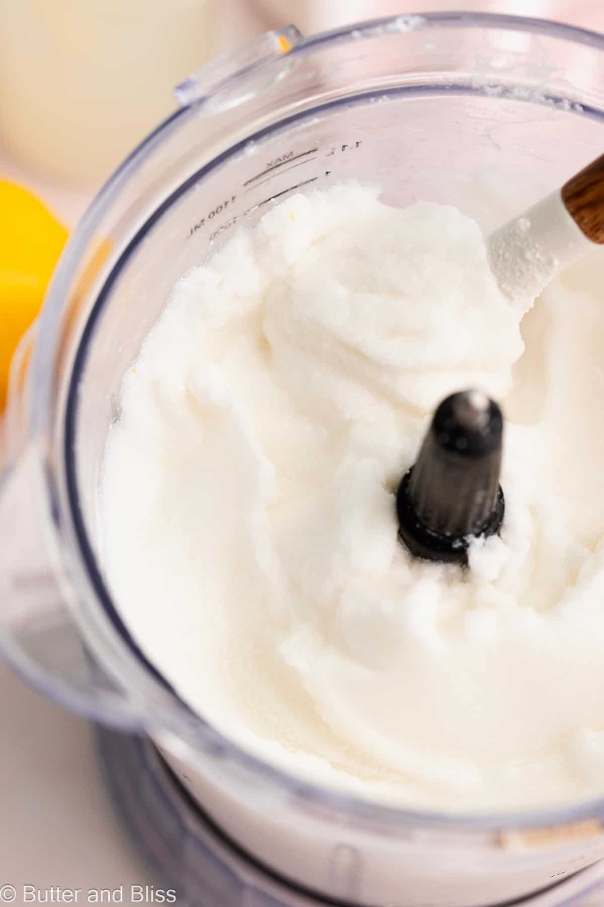 The inside of a blender of whipped lemonade made with coconut milk.