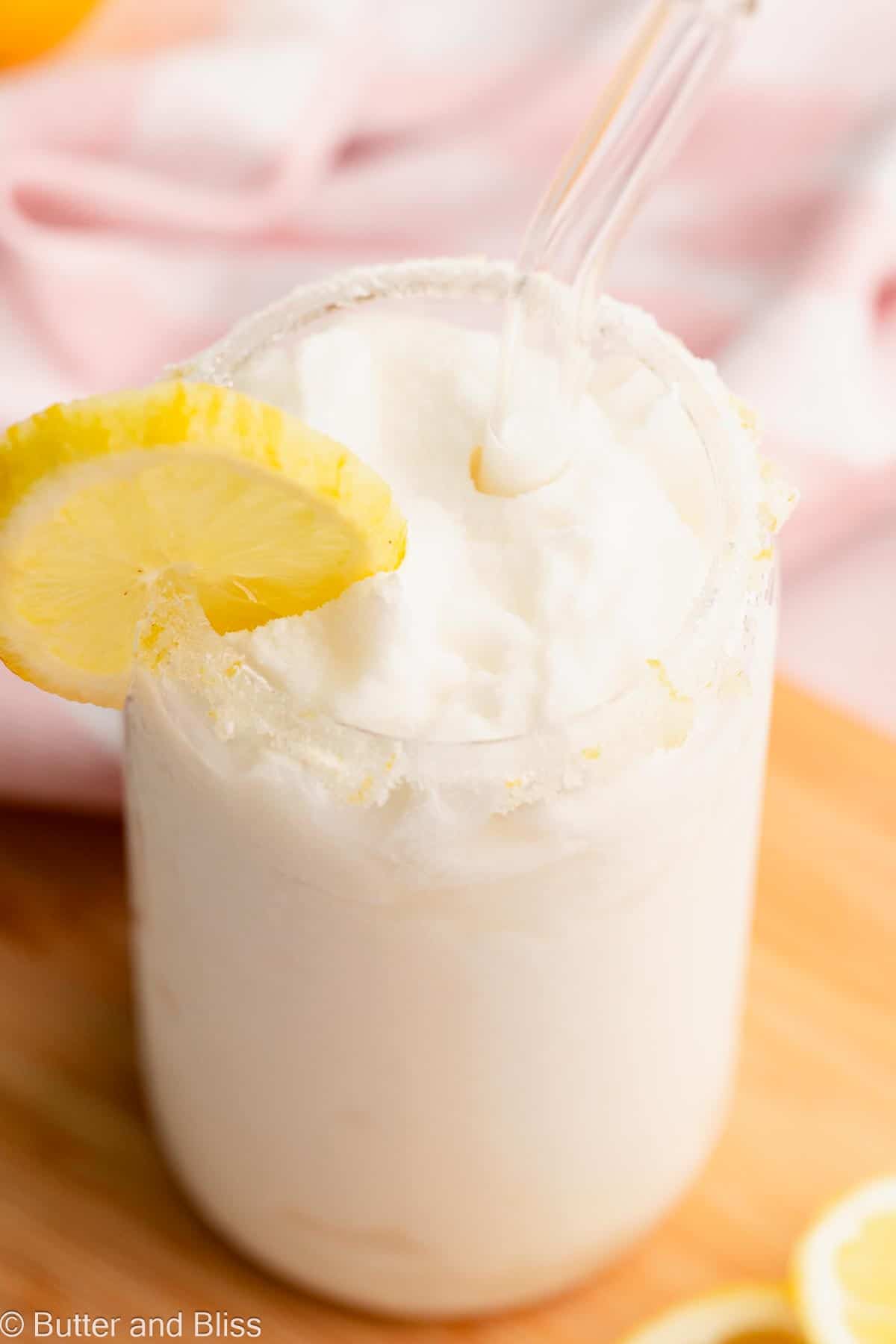 Look inside a glass of whipped frozen lemonade with a sugar rim.