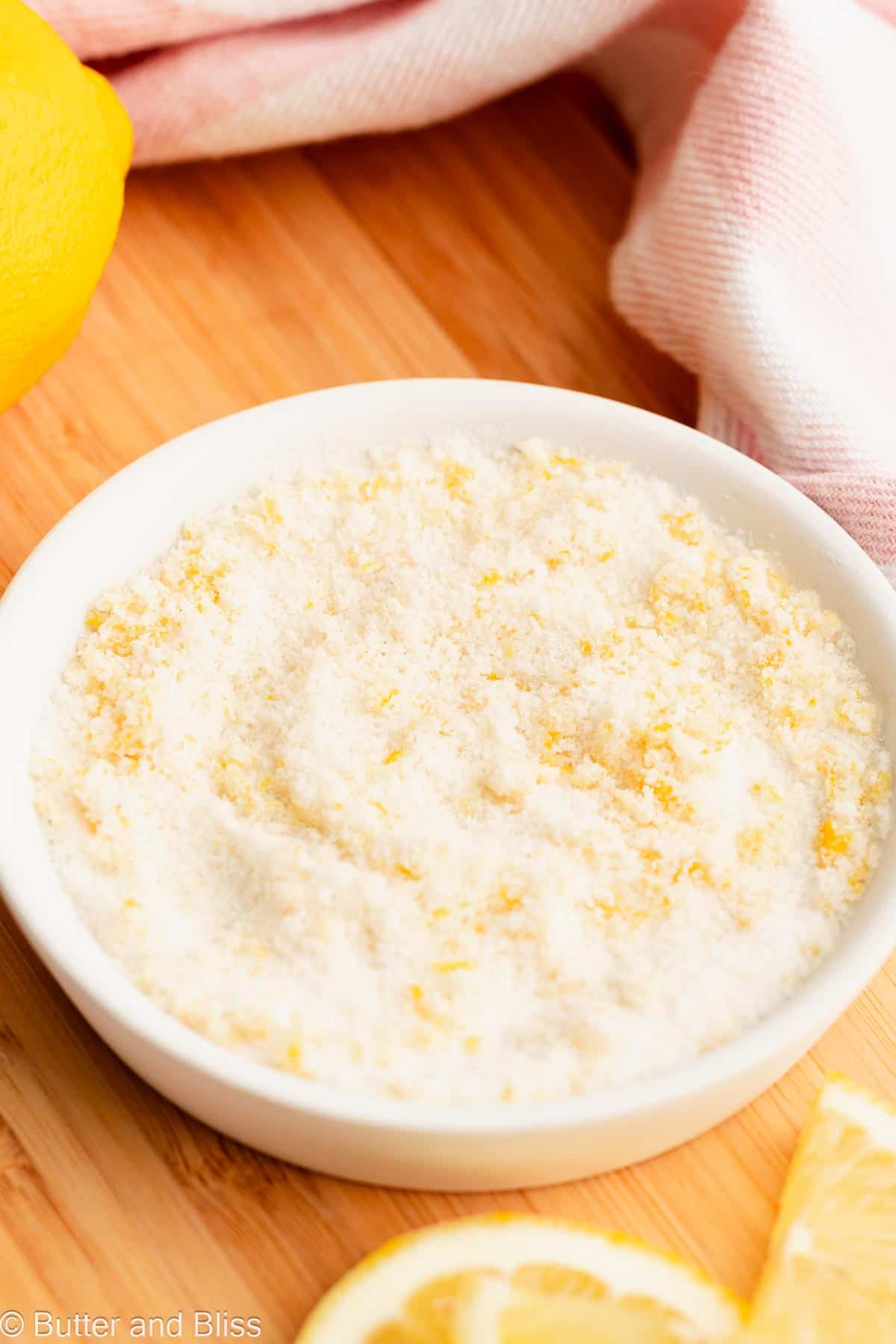 Small white plate full of lemon sugar.