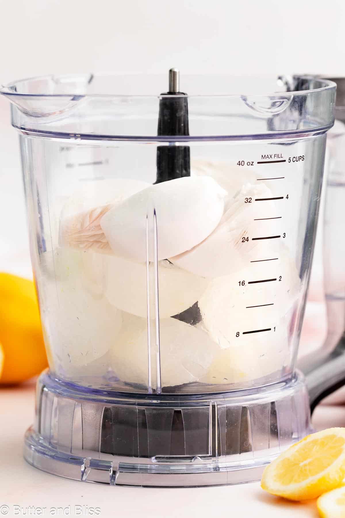 Blender full of lemonade and coconut milk cubes.