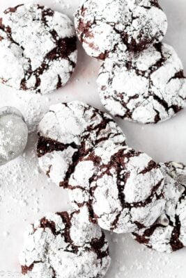 Fudgy chocolate crinkle cookies arranges on a table.