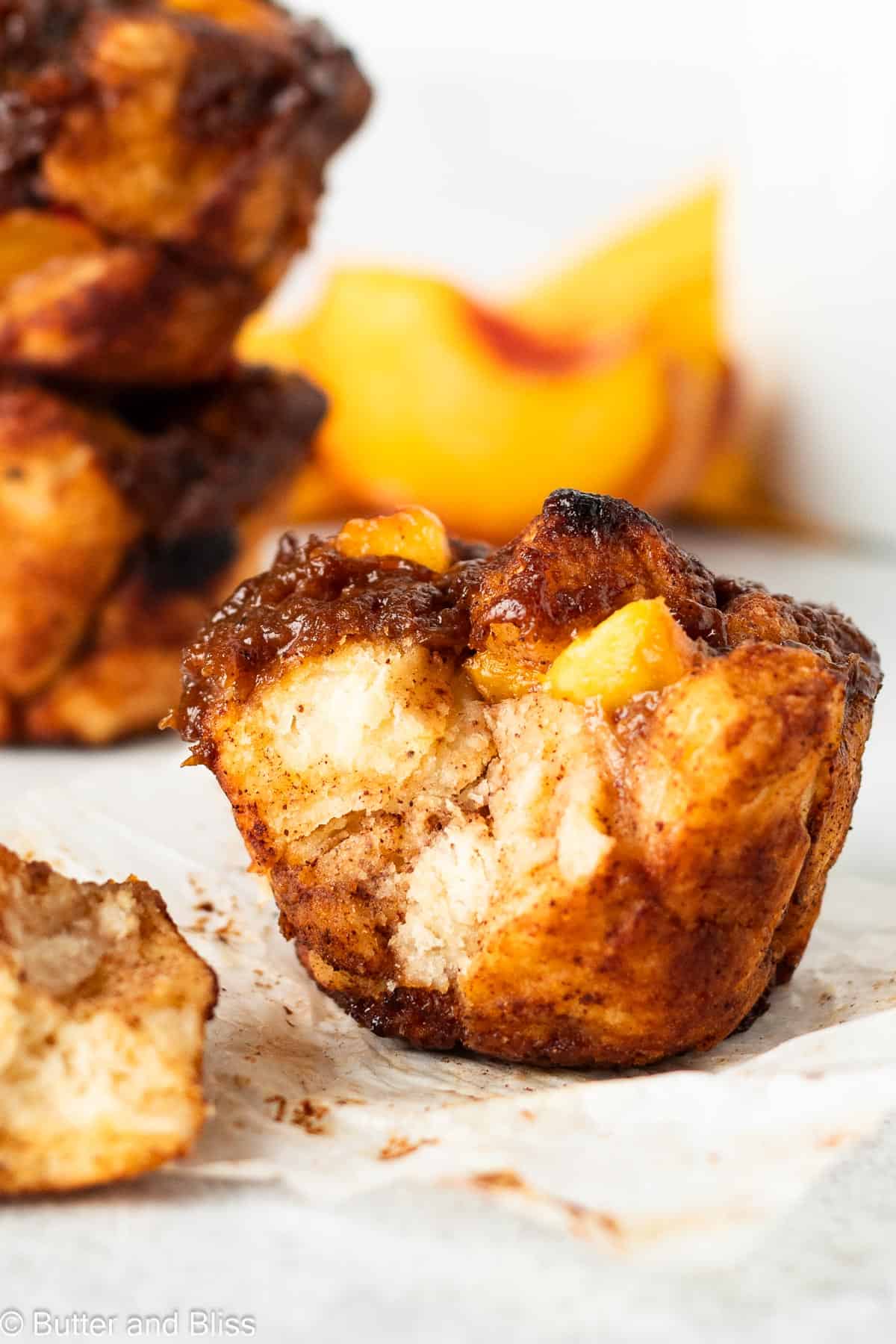 Peach monkey bread muffin with a bite.